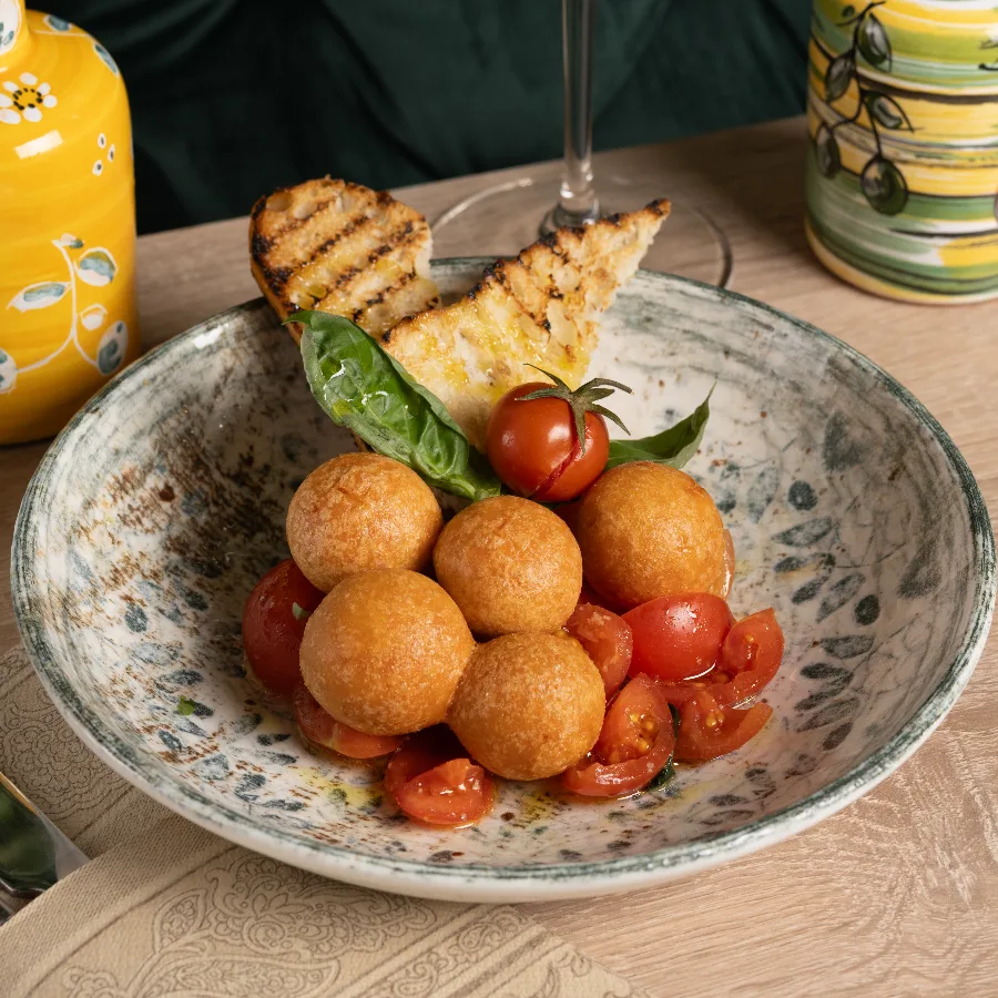 Bocconcini di parmigiano fritti, con insalata di pomodorini e basilico